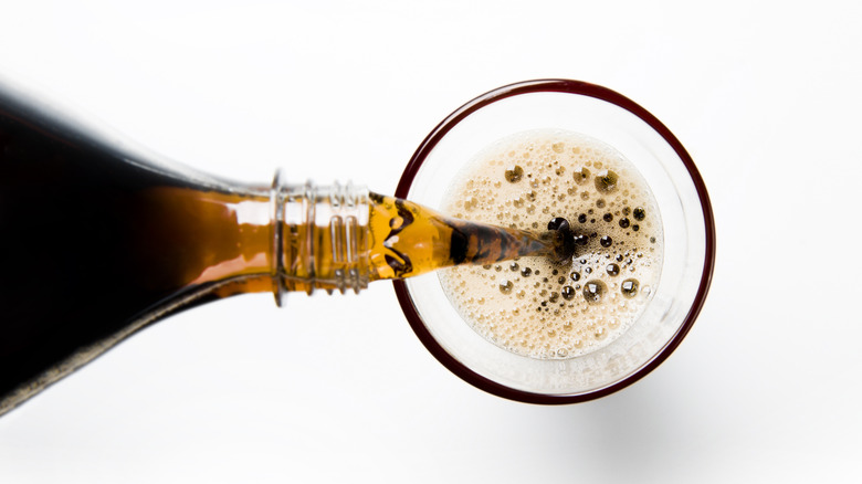 Cola being poured into glass, view from above