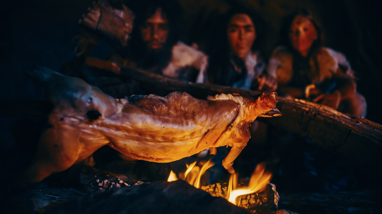 Cavemen preparing meat