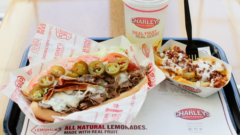 Charleys cheesesteak, fries, and drink on tray