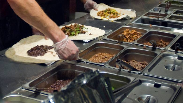 Chipotle workers preparing food