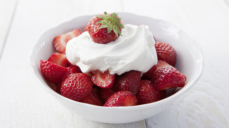 Bowl of strawberries with whipped cream