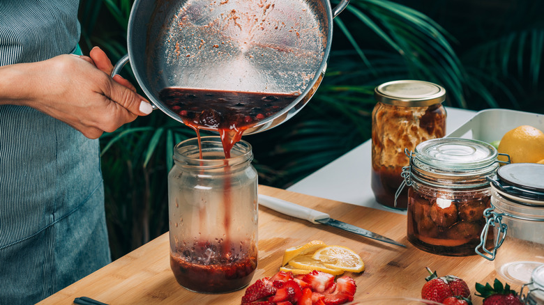 Woman home canning jam