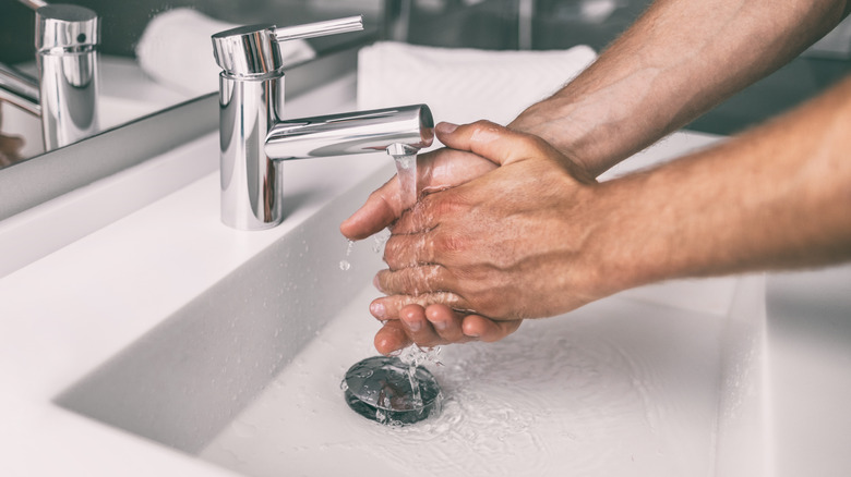 a person washing their hands