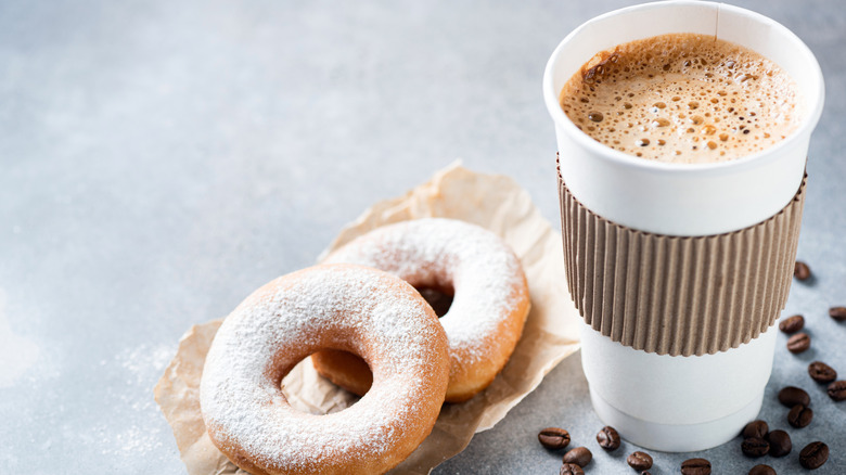 A coffee and two donuts