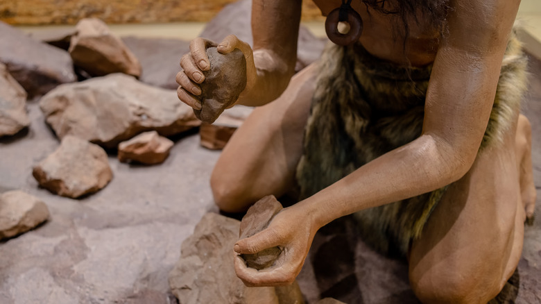 Prehistoric man preparing heat stones