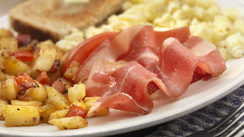 turkey bacon on plate with potatoes and eggs