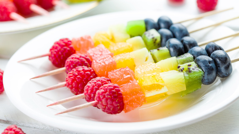 Rainbow fruit kebabs on a plate