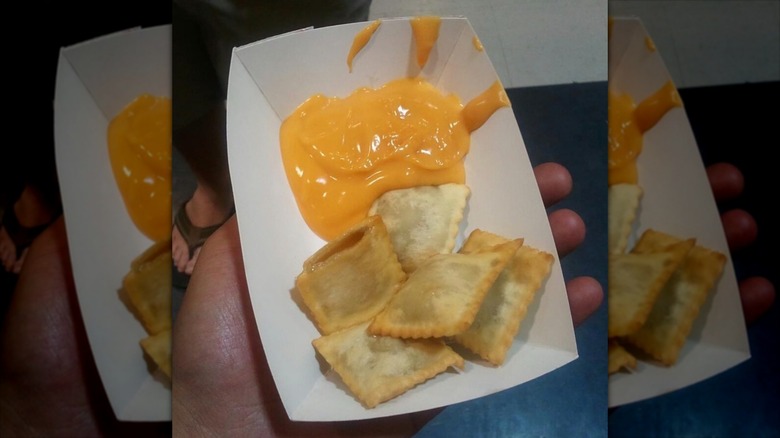 man holding cheesy fried beer 