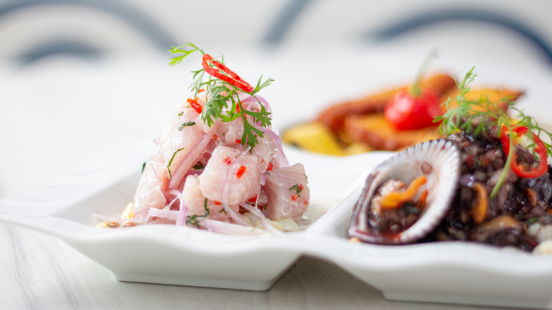 A plate of ceviche with herbs and spices