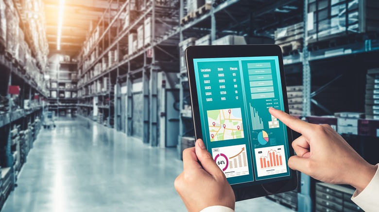 Worker holding tablet in warehouse