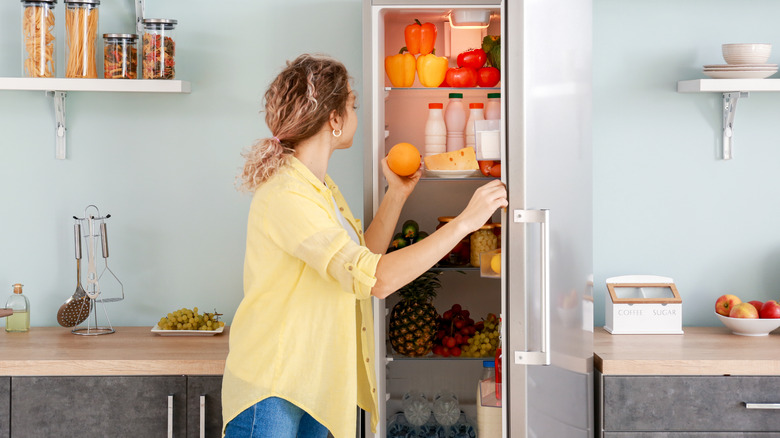 Woman looking in fridge