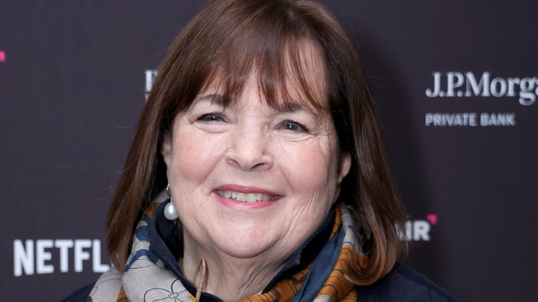 Ina Garten smiles with pearl earrings and scarf