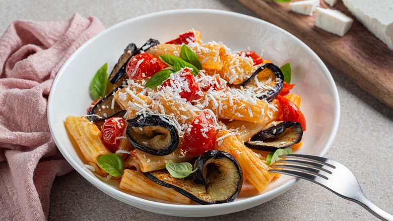 Penne pasta garnished with ricotta salata