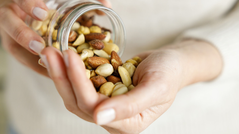 Jar of soy beans pouring into hands