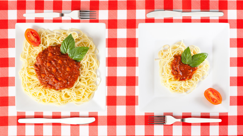 spaghetti portions on checkered cloth