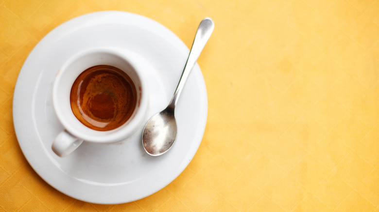 Cup of espresso on a yellow background