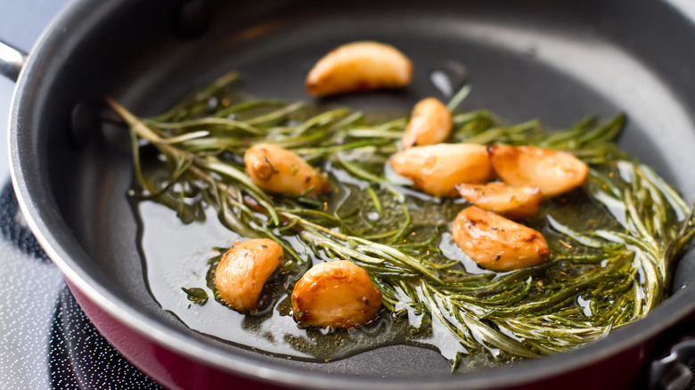 rosemary, garlic, and oil in pan