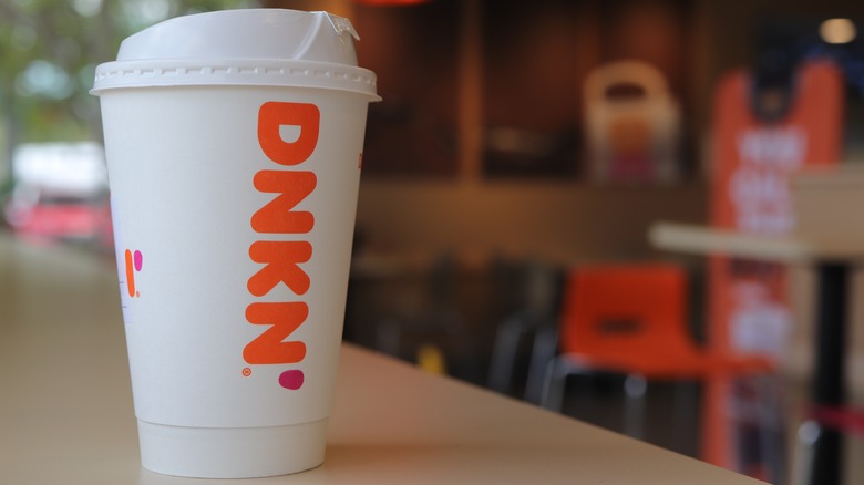 dunkin' hot coffee cup on counter