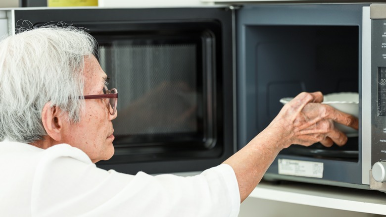 Person microwaving a bowl