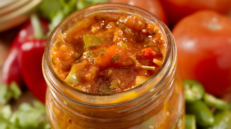 Salsa in jar with ingredients