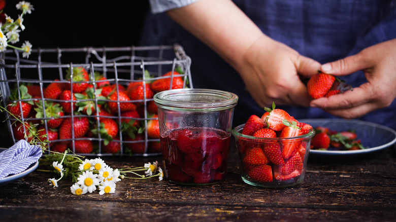 Person canning strawberries