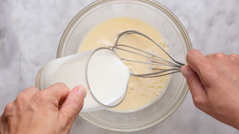 Pouring milk into pancake batter