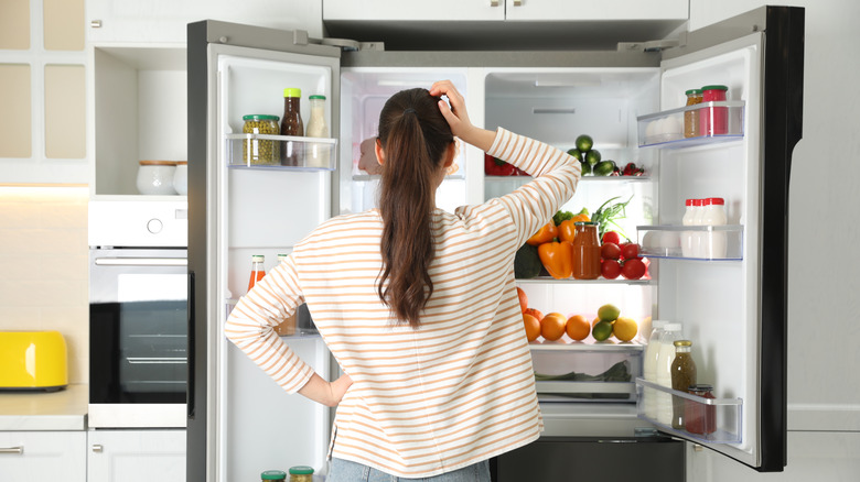 woman in front of refrigerator 
