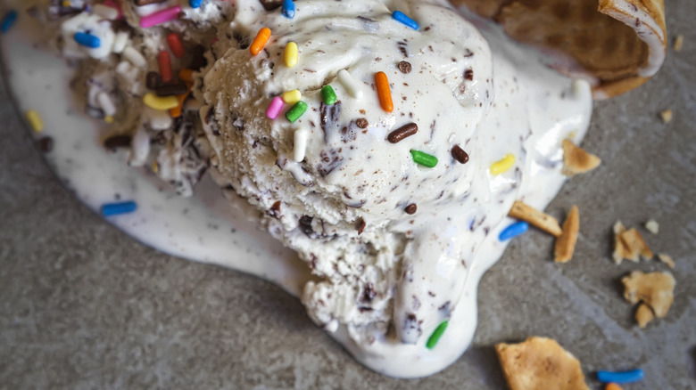 Melted ice cream with cracked cone and sprinkles