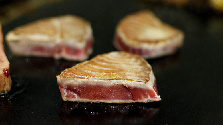 Ahi tuna cooking on a flat top