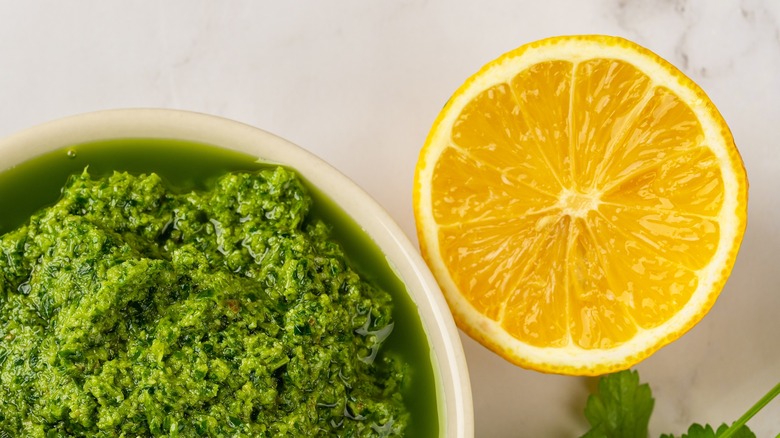 pesto with a lemon wedge beside