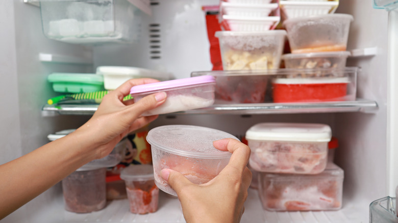 hand removing container from freezer