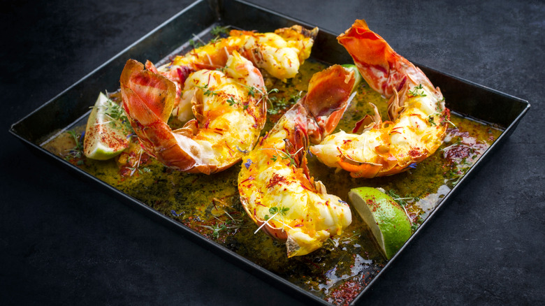 Lobster tails with butter, herbs, and limes