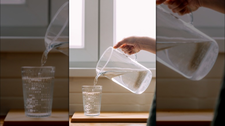 Water being poured from a pitcher into a glass