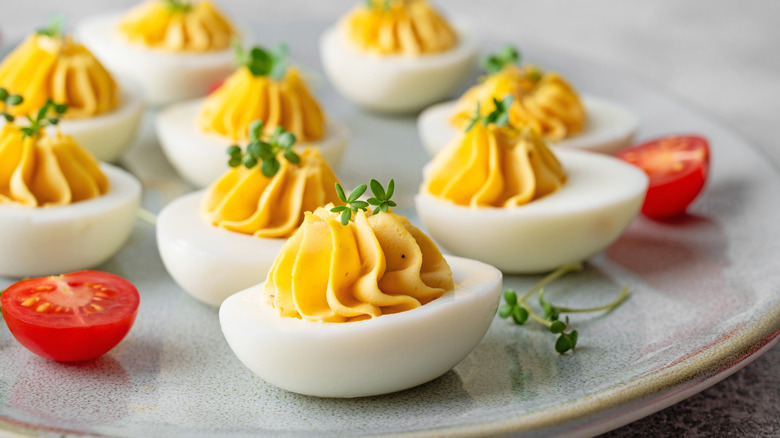 Deviled eggs with microgreen garnish and cherry tomatoes