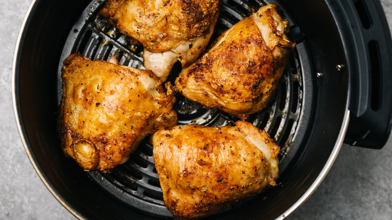 Chicken thighs in air fryer basket