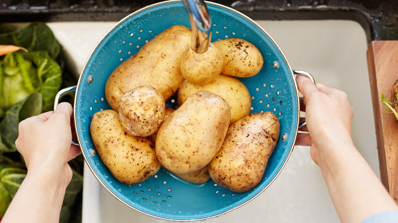 rinsing potatoes in colander 