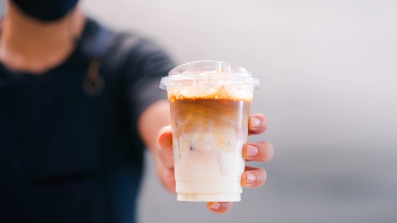 Person holding an iced latte