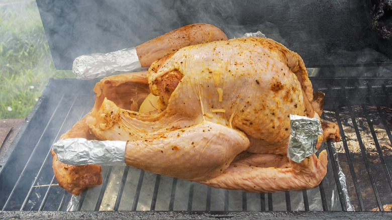 Turkey smoking on grill