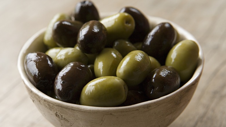 Closeup of a bowl of black and green olives