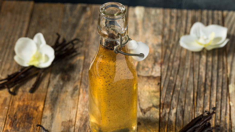 Vanilla bean syrup in bottle on wooden table