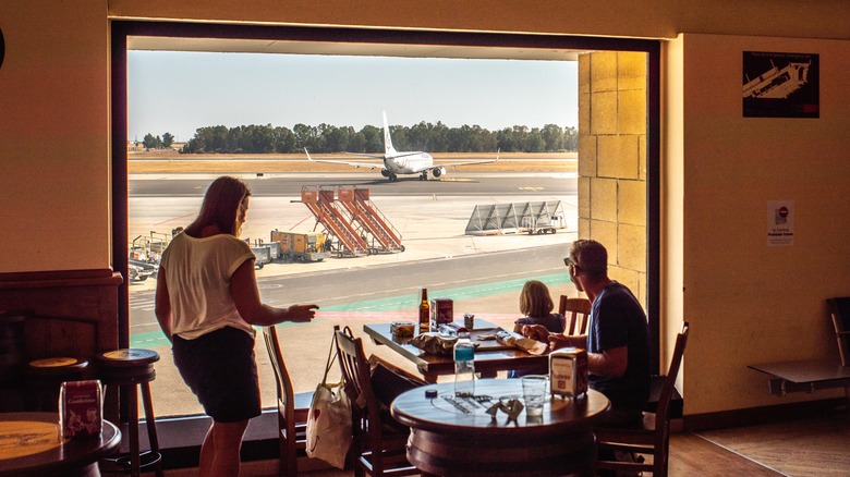 Family eating meal at airport