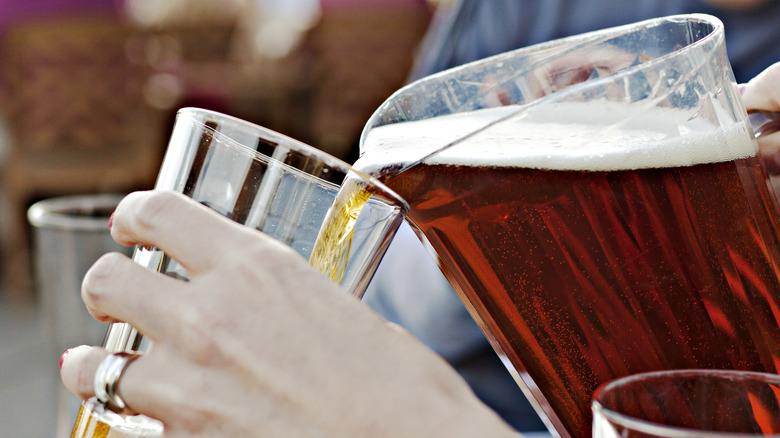 pouring beer from a pitcher