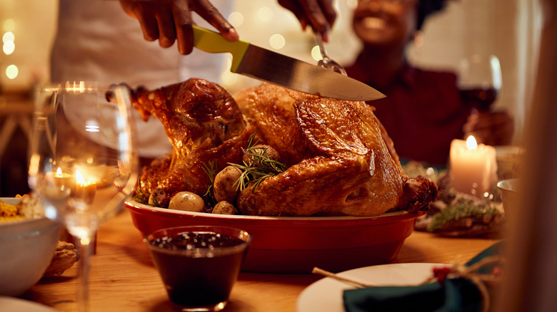 Person carving roast turkey