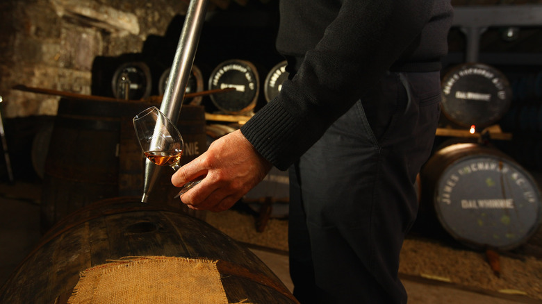 whiskey being drawn from cask