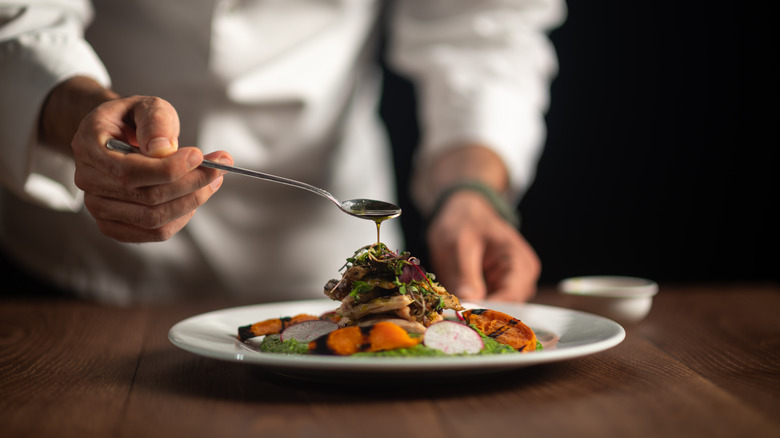 Fine dining chef prepares plate 