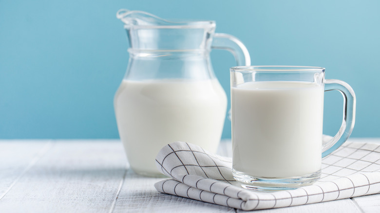 a pitcher and glass of milk