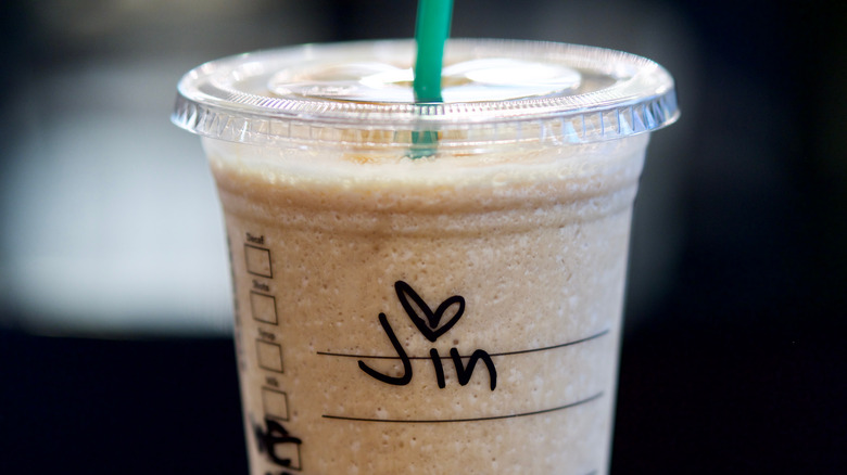 Close-up of a Starbucks cup with a handwritten name