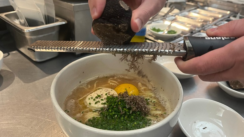 truffle shaving into ramen bowl