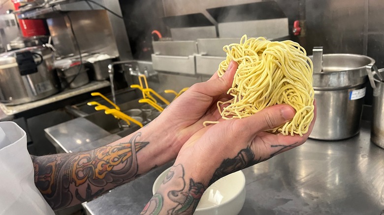 chef holding ramen noodles