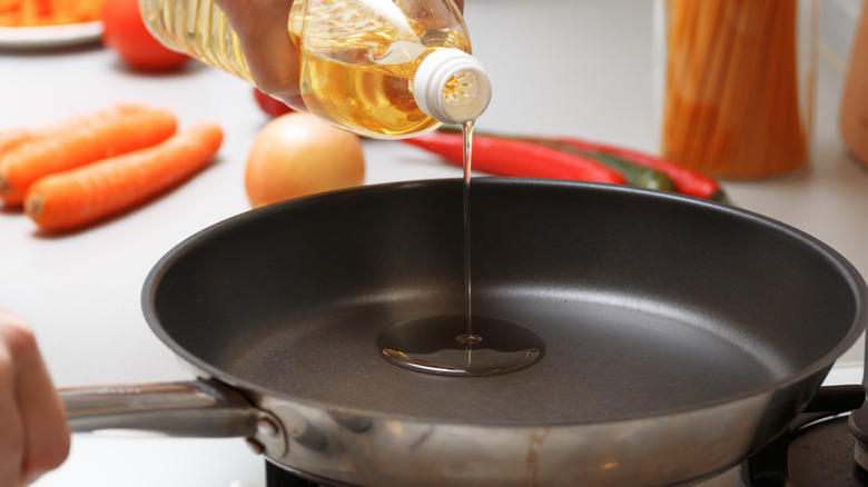 Pouring oil into pan